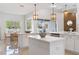 Open kitchen featuring white quartz countertops, dual islands, and stainless appliances at 28752 Falling Leaves Way, Wesley Chapel, FL 33543