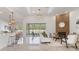 Open-concept living room with wood accent wall, modern furnishings, and seamless transition to outdoor space at 28752 Falling Leaves Way, Wesley Chapel, FL 33543