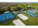 Aerial view of the community sports courts including tennis, pickleball, and beach volleyball at 28752 Falling Leaves Way, Wesley Chapel, FL 33543