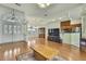 Open-concept living area with hardwood flooring, ceiling fan, and seamless flow to the kitchen at 3024 Dumas Ave, Spring Hill, FL 34609