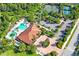 Aerial view of the community pool and clubhouse area, with tennis courts and parking at 3130 Forsythia Dr, Odessa, FL 33556