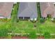 Aerial view of a well-maintained home with a tile roof, landscaped yard, and screened-in patio at 3130 Forsythia Dr, Odessa, FL 33556
