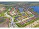 Panoramic view of a community showcasing homes with tile roofs, picturesque ponds, and winding roads, offering suburban charm at 3130 Forsythia Dr, Odessa, FL 33556