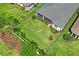 An aerial view of the backyard features a spacious lawn, screen porch, and manicured landscaping at 3130 Forsythia Dr, Odessa, FL 33556