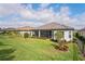 Beautiful backyard with lush green grass, mature landscaping, and a screened-in lanai at 3130 Forsythia Dr, Odessa, FL 33556