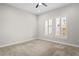 A simple empty bedroom with neutral paint, carpet and a large window at 3130 Forsythia Dr, Odessa, FL 33556