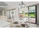 Cozy dining area with a round table, stylish chairs, and views of the outdoor lanai at 3130 Forsythia Dr, Odessa, FL 33556