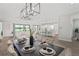 Elegant dining room features modern light fixture, and is open to the kitchen and living area at 3130 Forsythia Dr, Odessa, FL 33556