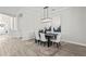 Formal dining room with modern chandelier, dark table, white upholstered chairs, and neutral decor at 3130 Forsythia Dr, Odessa, FL 33556