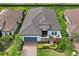 Beautiful exterior of a home with a well-manicured lawn, paved driveway, tile roof, and stone accents, showcasing architectural design at 3130 Forsythia Dr, Odessa, FL 33556