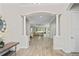 Inviting foyer with white columns, light wood-look tile flooring, and view into the bright, open living space at 3130 Forsythia Dr, Odessa, FL 33556