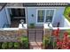 Charming front entrance with stone accents, iron gate, and inviting sitting area, offering curb appeal and welcoming ambiance at 3130 Forsythia Dr, Odessa, FL 33556