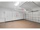 Well-organized garage with epoxy flooring, storage cabinets, overhead racks and convenient access to the house at 3130 Forsythia Dr, Odessa, FL 33556