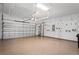 The spacious garage features epoxy flooring, overhead storage racks, and ample space for parking and storage at 3130 Forsythia Dr, Odessa, FL 33556