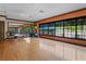 Community gym with wood floors, large mirrors, exercise equipment, and expansive windows for natural light at 3130 Forsythia Dr, Odessa, FL 33556