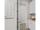 Hallway with storage cabinet, with neutral paint, tile flooring, and well-lit space at 3130 Forsythia Dr, Odessa, FL 33556