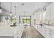 Bright kitchen featuring a large island with seating, modern lighting, and stainless steel appliances at 3130 Forsythia Dr, Odessa, FL 33556