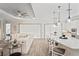 Open living area featuring modern decor, tile flooring, and a large kitchen island with bar seating at 3130 Forsythia Dr, Odessa, FL 33556