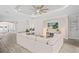 Bright living room with tile floors, tray ceiling, large windows, and comfortable white sofa at 3130 Forsythia Dr, Odessa, FL 33556