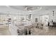 Open-concept living room flowing into the kitchen, featuring a large sectional and modern decor at 3130 Forsythia Dr, Odessa, FL 33556