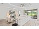 Bright living room with modern decor, a ceiling fan and sliding glass doors to the patio at 3130 Forsythia Dr, Odessa, FL 33556