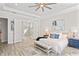 Bright main bedroom with tray ceilings, tile floors, and an ensuite bathroom with glass shower at 3130 Forsythia Dr, Odessa, FL 33556