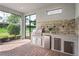 Outdoor kitchen with grill, sink, storage and countertop space for entertaining at 3130 Forsythia Dr, Odessa, FL 33556