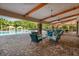 Inviting outdoor lounge area with comfortable seating, ceiling fans, and views of the community pool at 3130 Forsythia Dr, Odessa, FL 33556