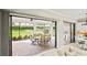 Covered patio featuring a dining area with views of the lush backyard at 3130 Forsythia Dr, Odessa, FL 33556