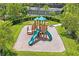 Aerial view of a community playground with a slide, climbing features, and soft ground cover at 3130 Forsythia Dr, Odessa, FL 33556