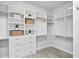 Organized walk-in closet with built-in shelving, drawers, and ample storage space at 3130 Forsythia Dr, Odessa, FL 33556