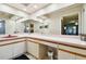 Bathroom with a large vanity, cabinets, and an enormous mirror to reflect the light at 3273 Bluestone Ave, Spring Hill, FL 34609