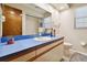 Bathroom featuring blue countertops, white cabinets, and a large mirror at 3273 Bluestone Ave, Spring Hill, FL 34609