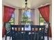 Charming dining room with a large bay window and a stylish chandelier above the table at 3273 Bluestone Ave, Spring Hill, FL 34609