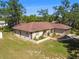 Aerial shot of the property shows its well-maintained landscaping, mature trees, and ample green space at 3273 Bluestone Ave, Spring Hill, FL 34609