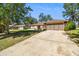 Street view of a one story residence with beautiful landscaping and an attached two-car garage at 3273 Bluestone Ave, Spring Hill, FL 34609