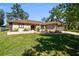 A lovely one-story home with beautiful landscaping, a manicured lawn, and a two-car garage at 3273 Bluestone Ave, Spring Hill, FL 34609