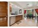 Kitchen and dining area featuring stainless steel appliances, wood cabinetry, and a window with backyard views at 3273 Bluestone Ave, Spring Hill, FL 34609