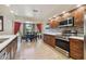 Bright eat-in kitchen with stainless steel appliances, wood cabinets, and a dining area near a window at 3273 Bluestone Ave, Spring Hill, FL 34609
