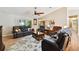 Spacious living room featuring modern furniture, vaulted ceilings, and an open view of the kitchen at 3273 Bluestone Ave, Spring Hill, FL 34609
