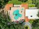 Spectacular aerial view of community pool and spa with ample lounge seating and lush landscaping at 3327 Golden Eagle Dr, Land O Lakes, FL 34639