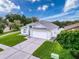 Beautifully landscaped single Gathering home featuring a two-car garage and meticulously maintained lawn at 3327 Golden Eagle Dr, Land O Lakes, FL 34639