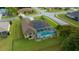 Aerial view of a home featuring a screened-in pool, solar panels, and a fenced-in yard at 3542 Conifer Loop, Spring Hill, FL 34609
