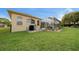 Lush backyard with mature trees and view of the screened pool at 3542 Conifer Loop, Spring Hill, FL 34609