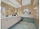 Spacious bathroom features dual sinks, a soaking tub, and a separate glass-enclosed shower at 3542 Conifer Loop, Spring Hill, FL 34609