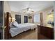 Cozy bedroom featuring a ceiling fan, closet, and furnishings at 3542 Conifer Loop, Spring Hill, FL 34609