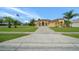 Charming, single story home with desert landscaping, concrete driveway, and visible American flag at 3542 Conifer Loop, Spring Hill, FL 34609