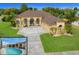 Stunning home with a large driveway, arched entryway, tropical landscaping, and a refreshing screened-in pool at 3542 Conifer Loop, Spring Hill, FL 34609