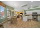 Open kitchen with stainless steel appliances, tile floors, breakfast nook, and seamless connection to the dining and living areas at 3542 Conifer Loop, Spring Hill, FL 34609