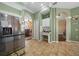 A spacious kitchen featuring modern appliances and an open layout with tile flooring and green paint at 3542 Conifer Loop, Spring Hill, FL 34609